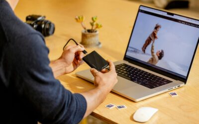 The-_Backup-Exit_-Strategy_-Can-You-Move-Your-Data-Without-the-Vendors-Help_-scaled.jpg A man sitting at a table with a laptop and cell phone