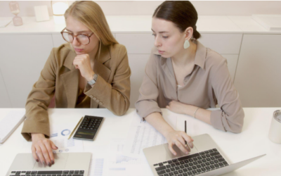 two women with laptops